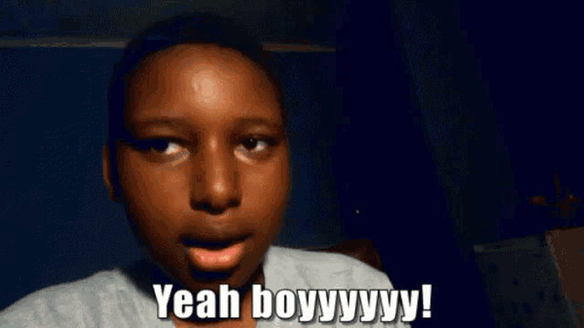 a young boy is making a funny face and says yeah boyyyy