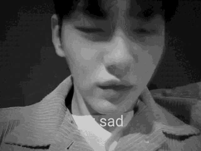 a black and white photo of a man 's face with the words `` yiz sad '' written on the bottom .
