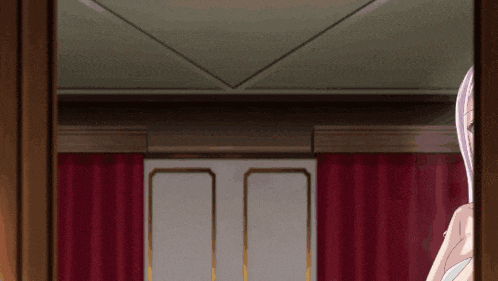a woman standing in a room with a red curtain behind her