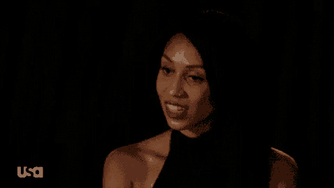 a woman is smiling in a dark room with usa written on the bottom