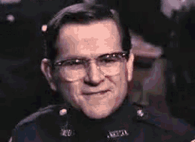 a man wearing glasses and a uniform that says ' n.c.p.d. ' on it