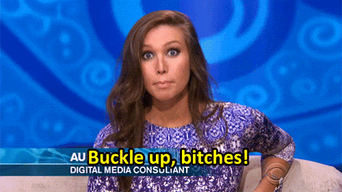 a woman sitting on a couch with a sign that says au buckle up bitches digital media consultant