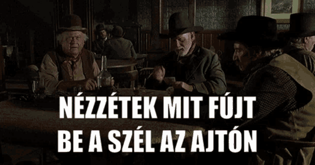 a group of men are sitting at a table with the words nezzetek mit fujit be a szel az ajton