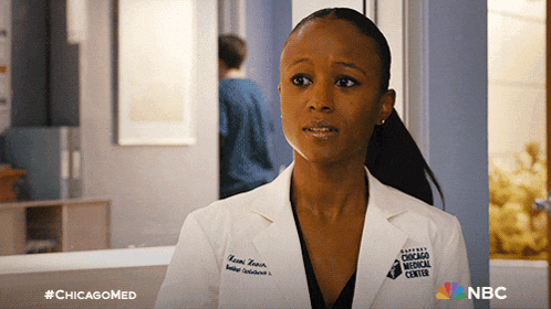 a woman in a lab coat from the chicago medical center looks at the camera