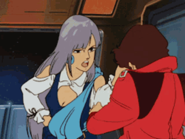 a man in a red jacket and a woman in a blue dress are standing next to each other