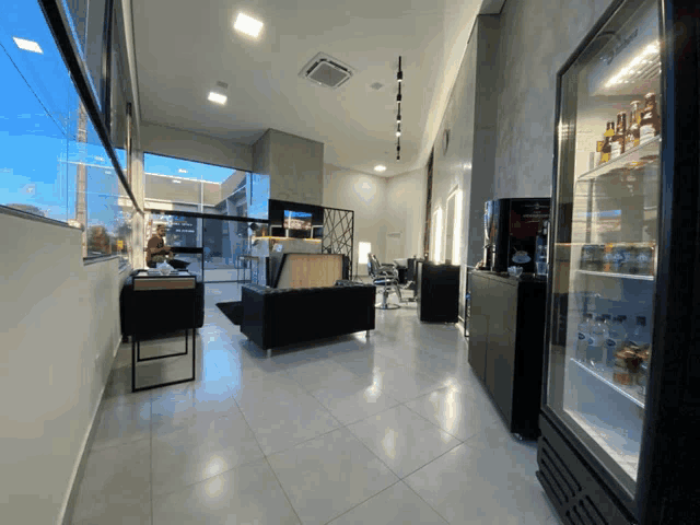 a barber shop with a fridge filled with bottles of alcohol