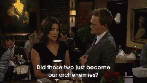 a man and a woman are sitting at a table and the man says did those two just become our archenemies