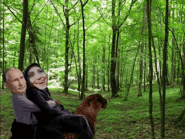 a man and a woman are sitting in the woods with a cheetah