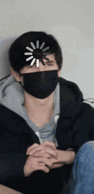 a man wearing a black mask with a loading screen on his face