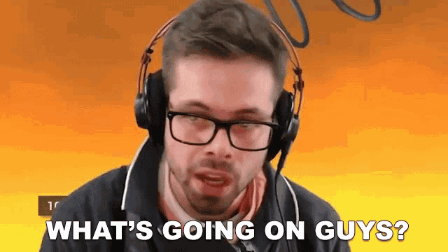 a man wearing headphones and glasses is asking what 's going on guys