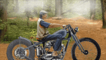 a man riding a motorcycle in the woods
