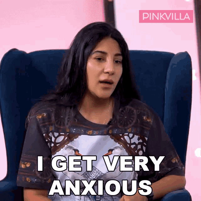a woman sitting in a chair with the words i get very anxious on her shirt
