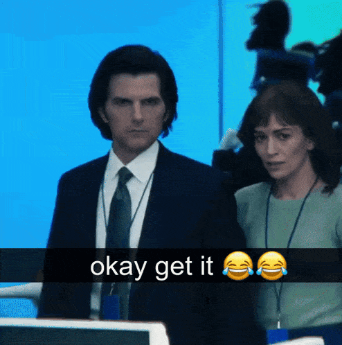 a man in a suit and tie is standing next to a woman with okay get it written on it