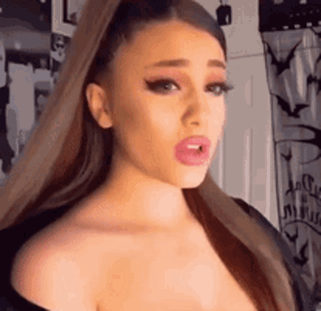 a close up of a woman 's face with a ponytail and pink lipstick .
