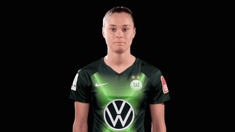 a woman wearing a green shirt with a vw logo
