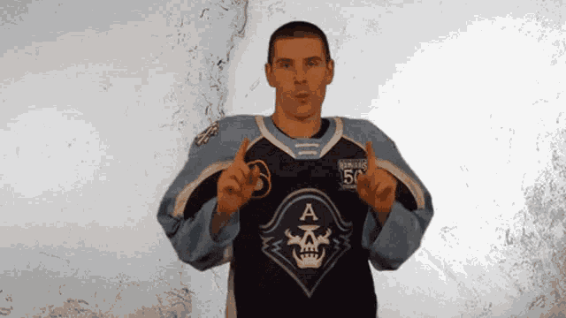 a man wearing a jersey with the letter a on the front