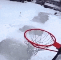 a basketball hoop in the snow with a picture of a man wearing a helmet