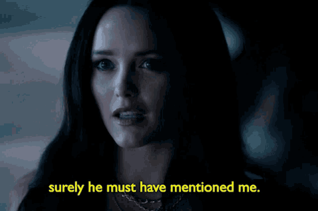 a woman says " surely he must have mentioned me " in a dark room