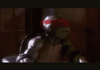 a close up of a teenage mutant ninja turtle wearing a blue cape