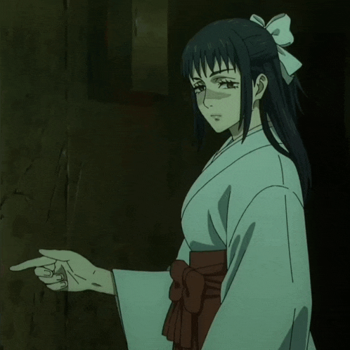 a woman in a kimono is pointing her finger