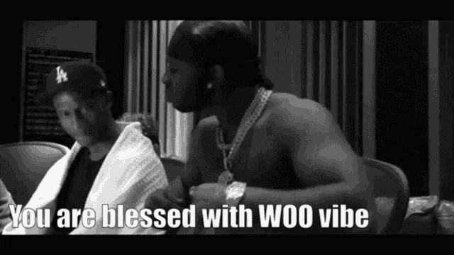 a black and white photo of two men with the words " you are blessed with woo vibe " at the bottom