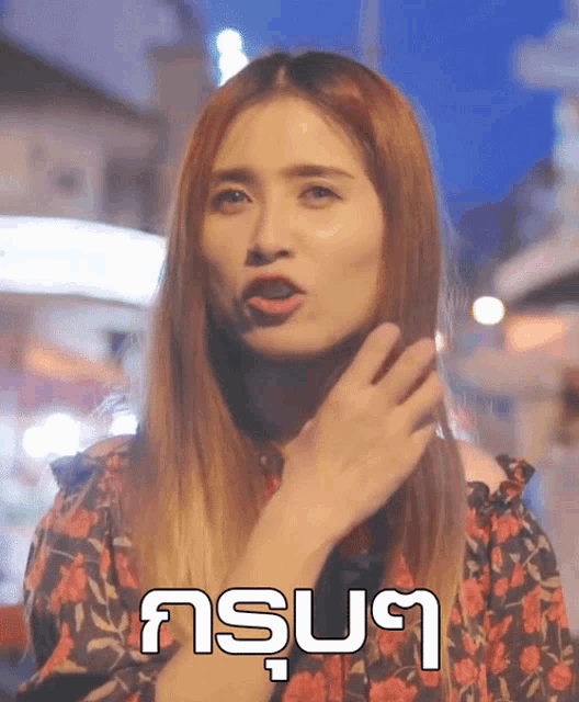 a woman is making a funny face in front of a sign that says ' asus '