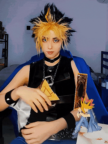 a woman in a costume is holding a pyramid and a yu gi oh card