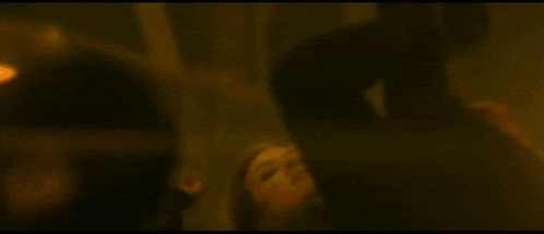 a man is doing push ups on a wet street at night