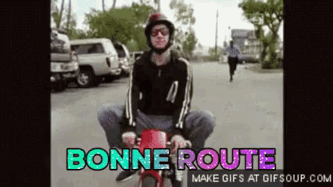 a gif of a man riding a motorcycle with the words bonne route on it
