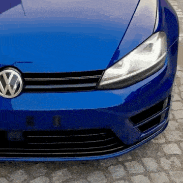 the front of a blue volkswagen golf is shown