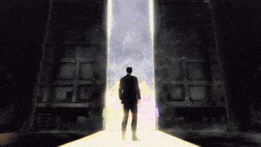 a man in a suit stands in front of a doorway