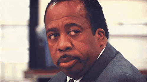 a man in a suit and tie is making a silly face