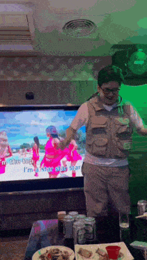 a man is standing in front of a television that says " i 'm a star star star "
