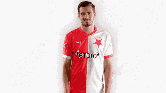 a man wearing a red and white shirt with etoro written on it