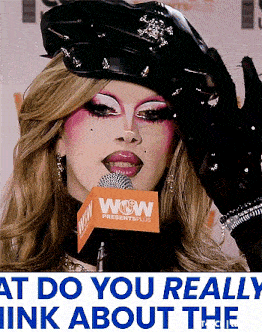 a woman wearing a hat and gloves talking into a wow microphone