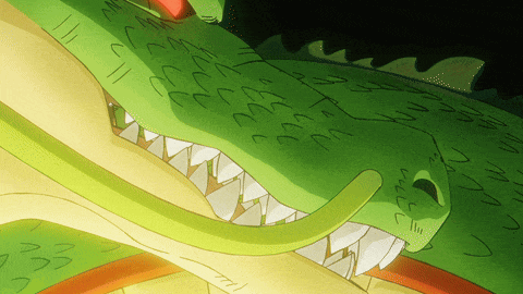 a close up of a dragon 's mouth with a few letters visible