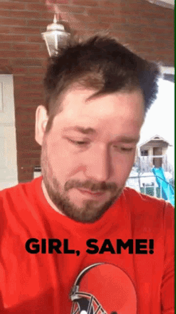 a man with a beard wearing a red shirt that says " girl same "
