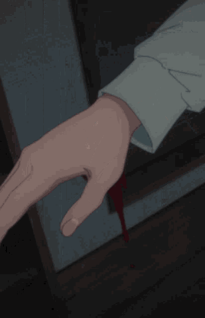 a close up of a person holding a red object in their hand