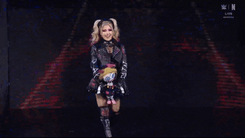 a woman in a gothic outfit is holding a stuffed animal that says pain
