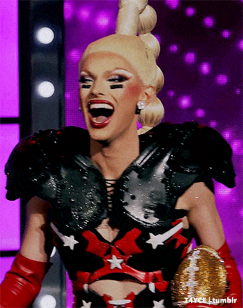 a drag queen wearing a black and red outfit with white stars on it