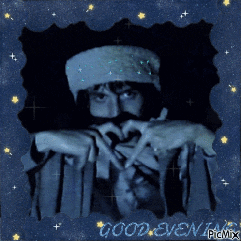 a picture of a man making a heart shape with his hands and the words " good evening " on the bottom
