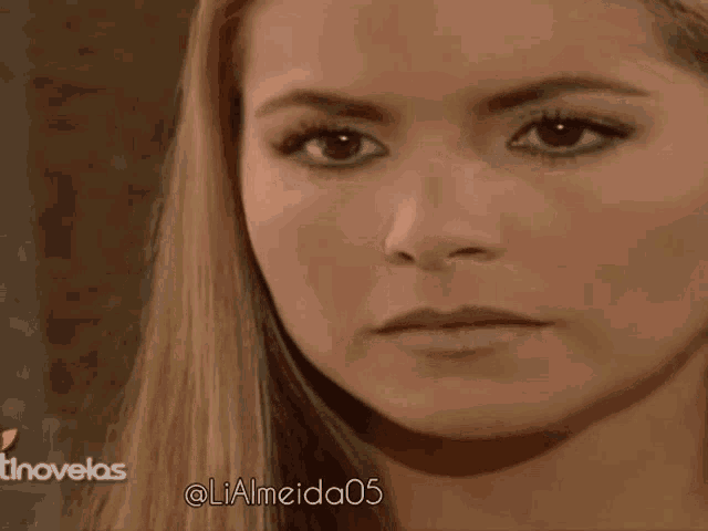 a close up of a woman 's face with the hashtag lialmeida05 on the bottom right