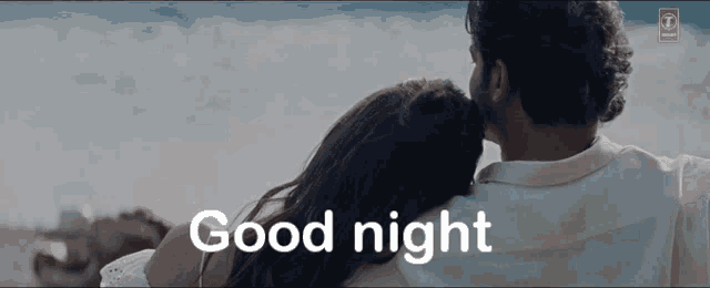 a man and a woman are hugging and the words good night are on the screen