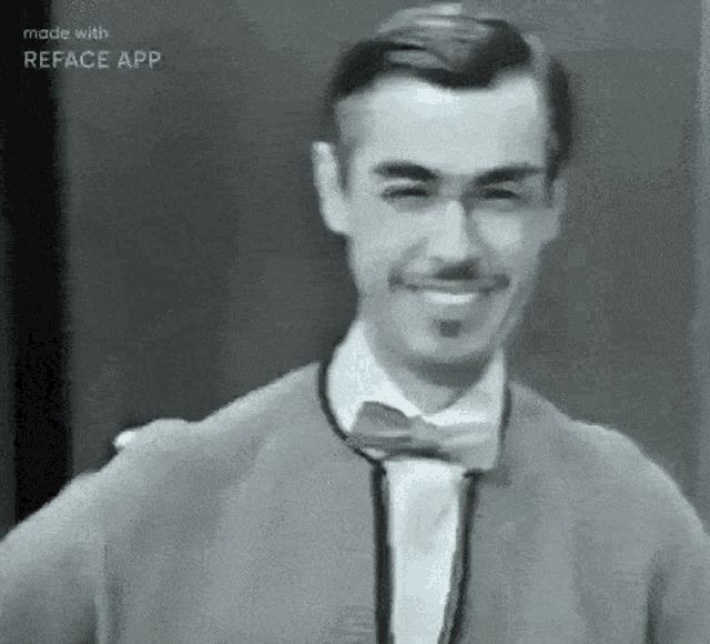 a black and white photo of a man wearing a bow tie and a jacket .