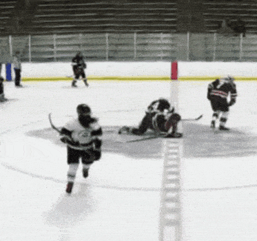 hockey players on the ice with one wearing a jersey with the letter g on it