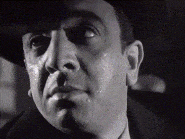 a man 's face is shown in a black and white photo