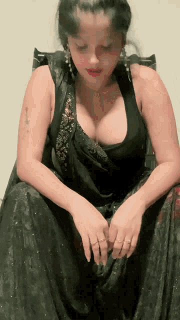 a woman wearing a black dress has a tattoo on her arm that says ' i love you '