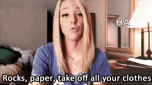 a woman in a blue shirt is saying rocks , paper , take off all your clothes
