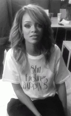 a woman is wearing a shirt that says shit fucking happys