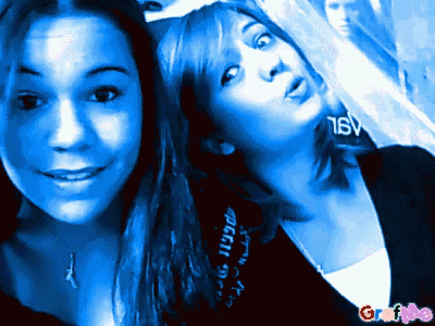 two girls are posing for a picture in front of a poster that says tsv